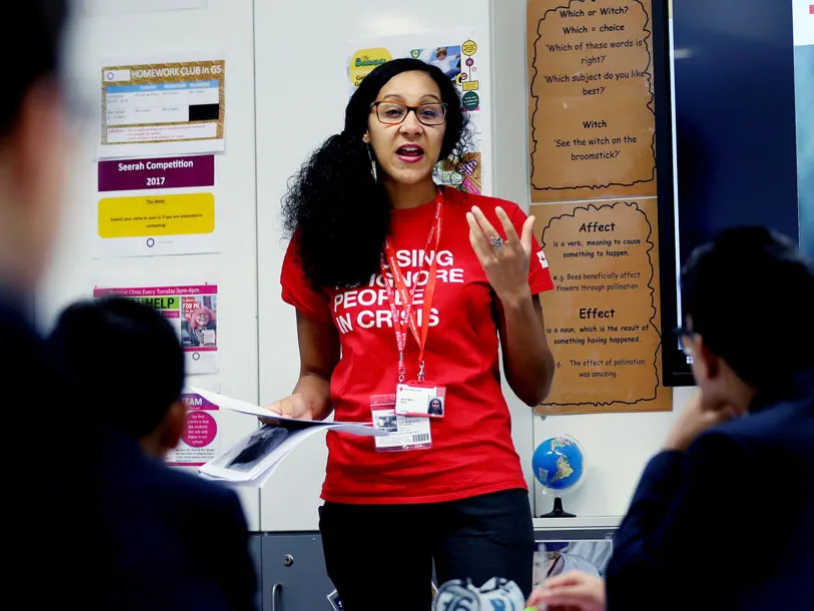 A British Red Cross trainer delivering training to a classroom of school pupils